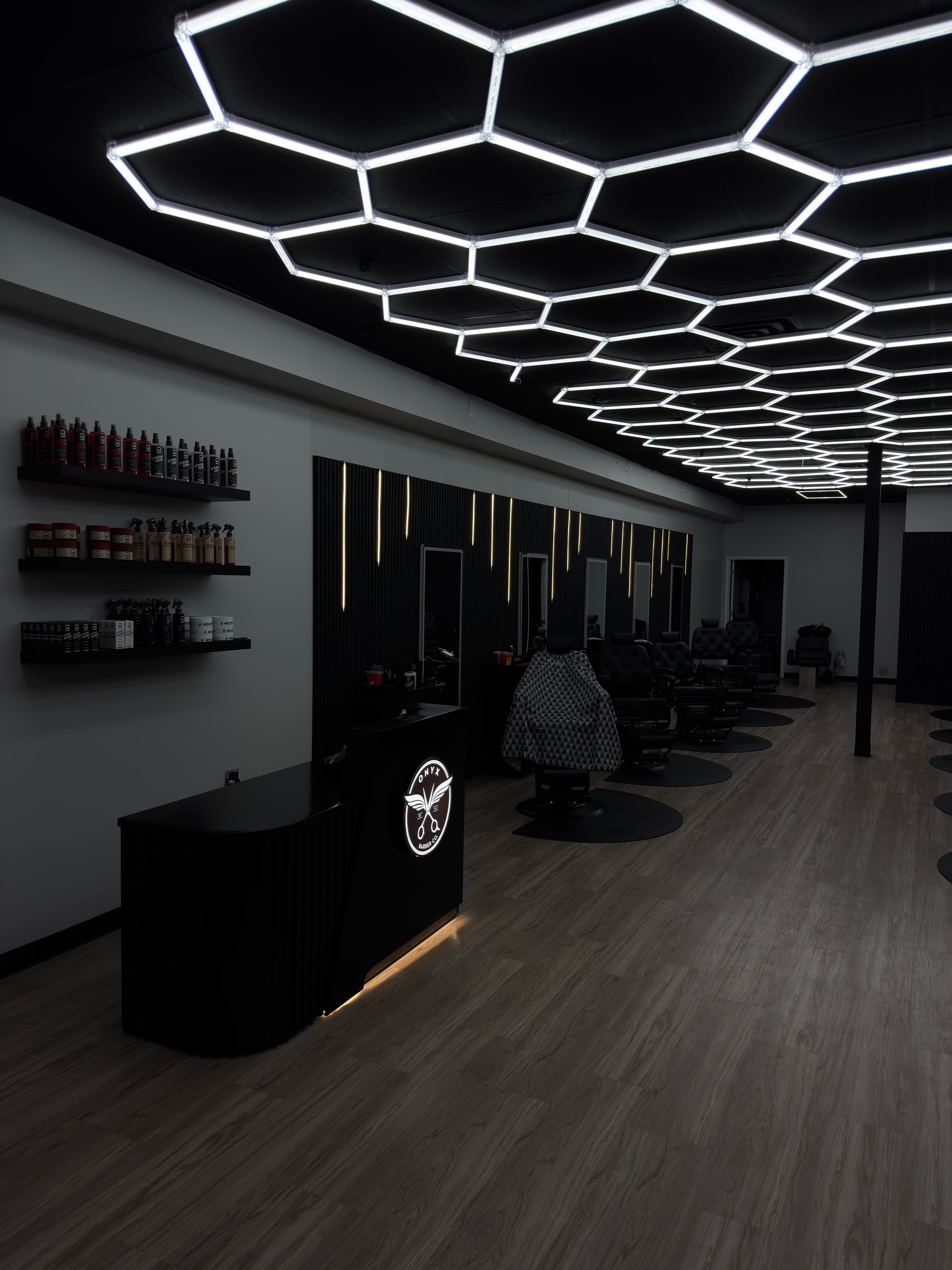 Inside the Onyx Barber Co. shop in Novi, Michigan, with hexagon ceiling lights over the chairs